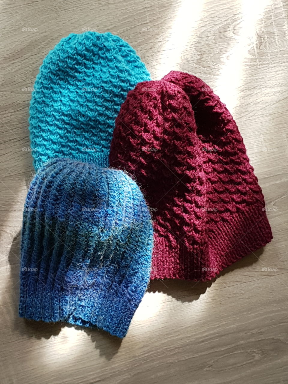 three knitted hats