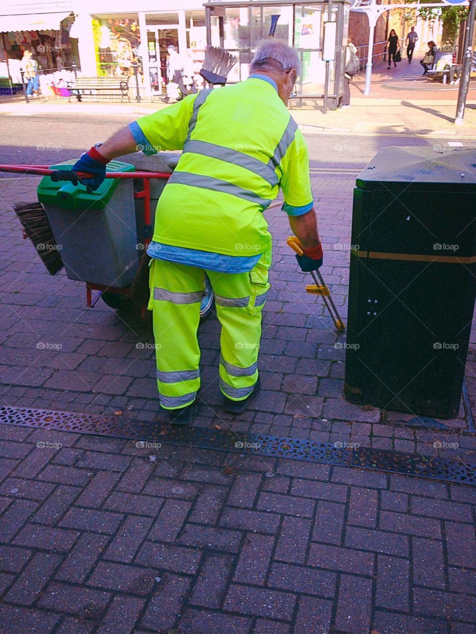 Elderly man working picking litter in England