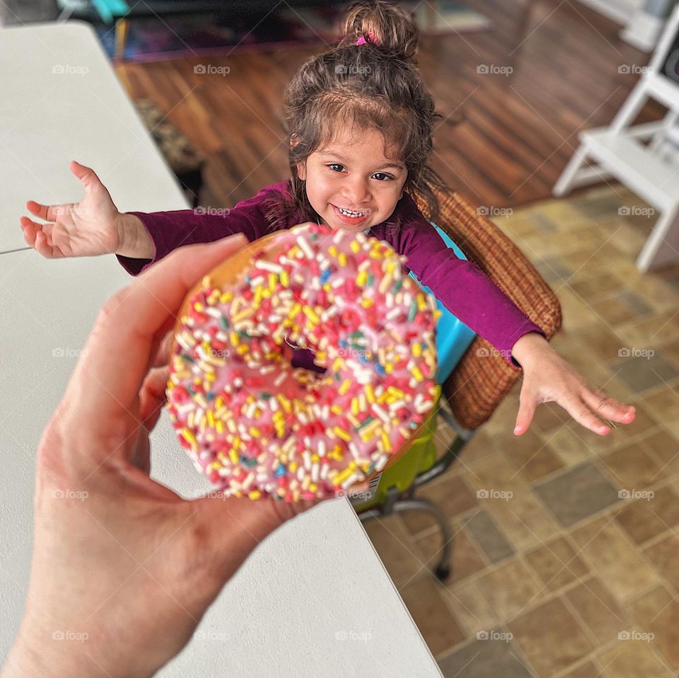 Toddler girl gets excited about a donut, toddler reaches for donut, circles in everyday life, geometric shapes all around us, pink frosted donut with sprinkles, holding a donut, mother holding donut for child, mother handing donut to toddler girl