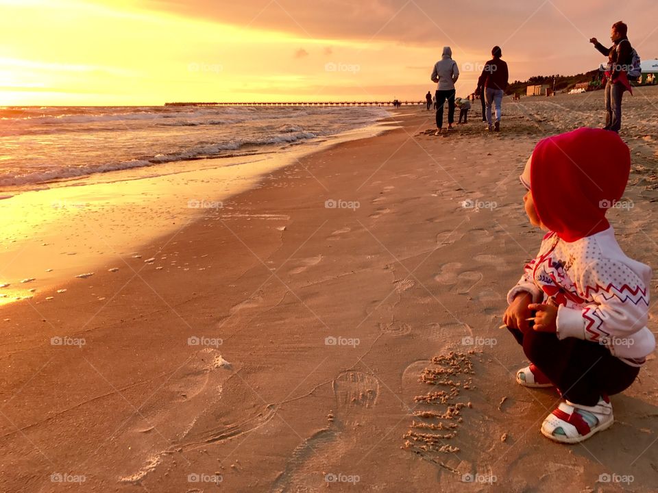 People enjoy the sunset on the beach 