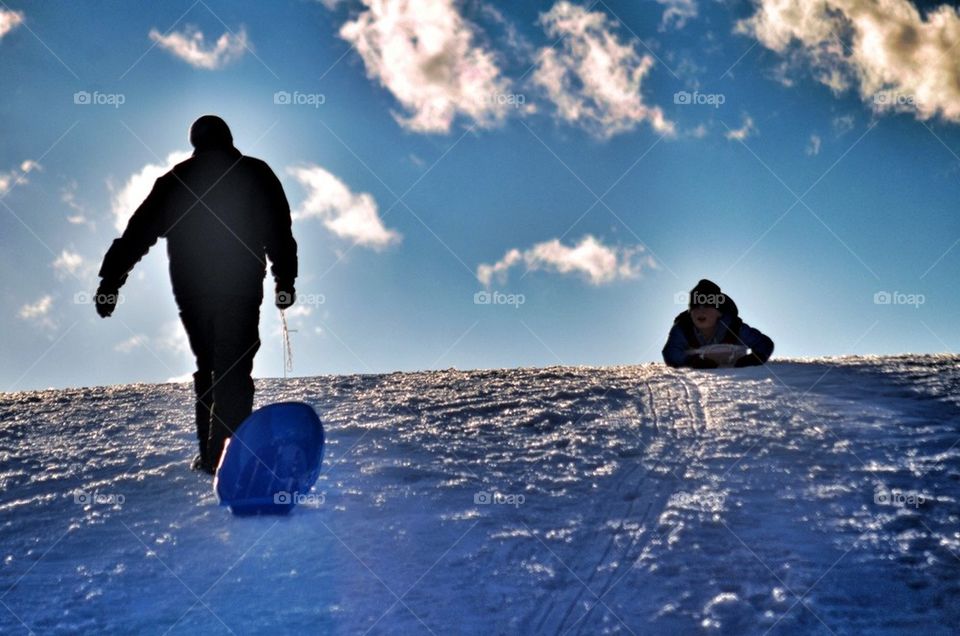 Daddy and son sledding