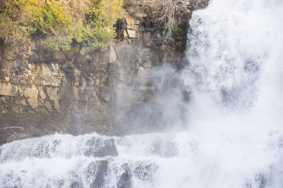 Waterfall falls against rocks 