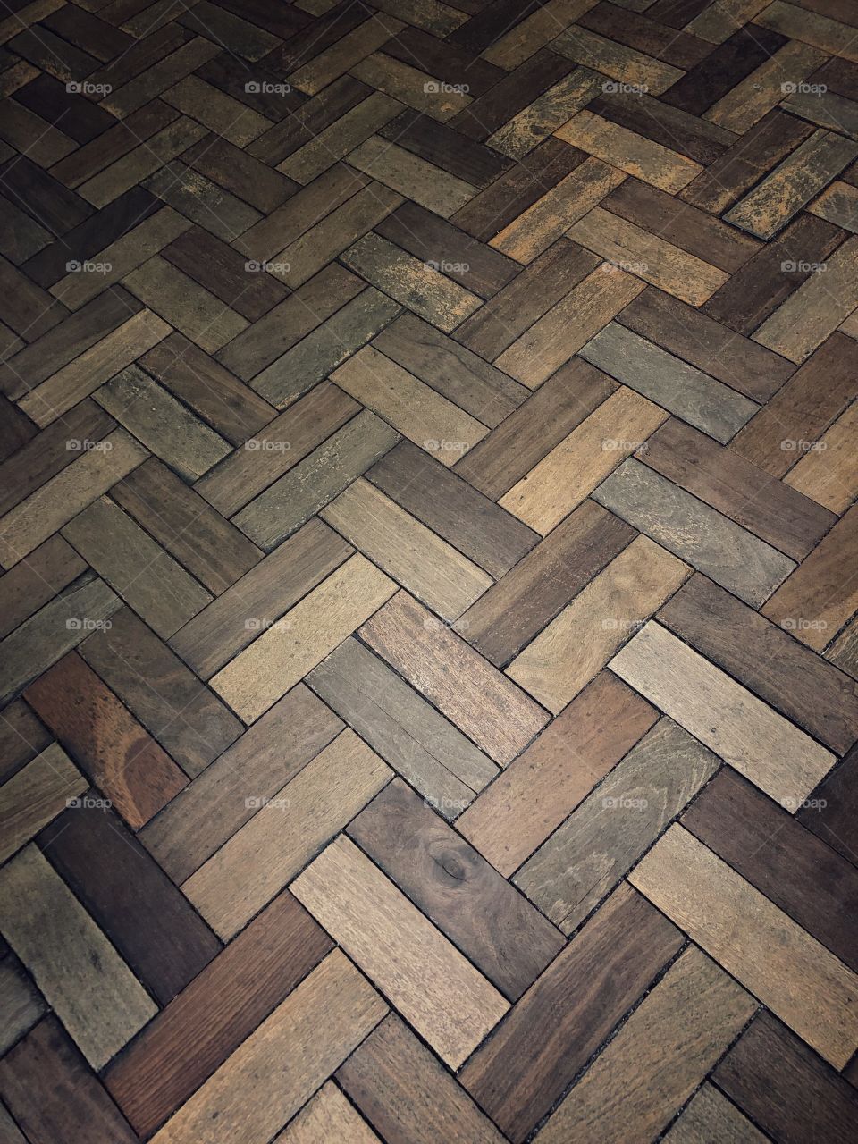 A beautiful pattern in the waiting room floor. Retangular pieces of wood creating a great pattern on the floor.