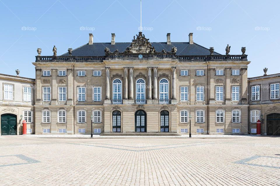 Amelienborg royal palace, old beautiful castle architecture in Copenhagen Denmark on sunny day with blue sky 
