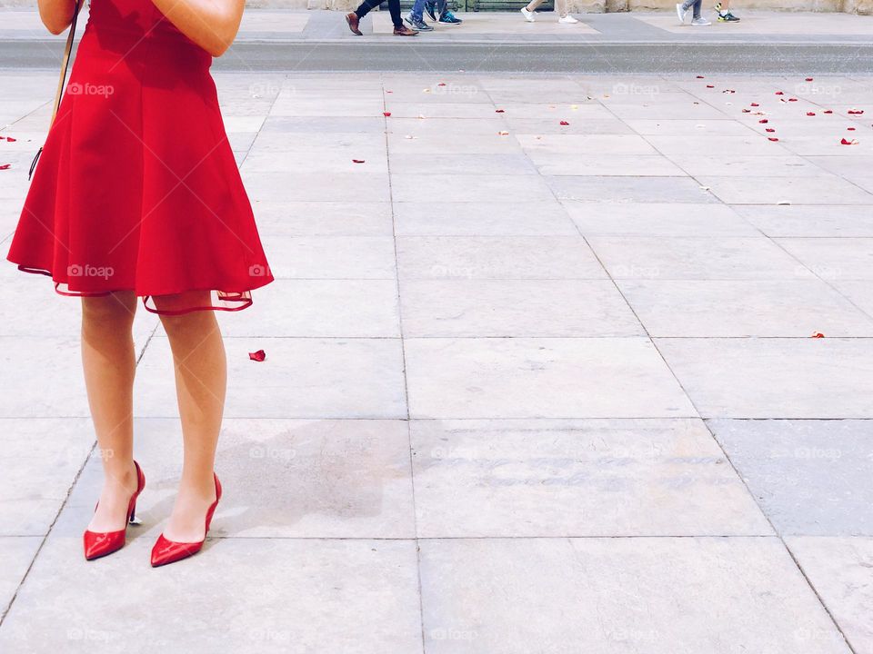 Woman in a cute dress and matching shoes on the street 