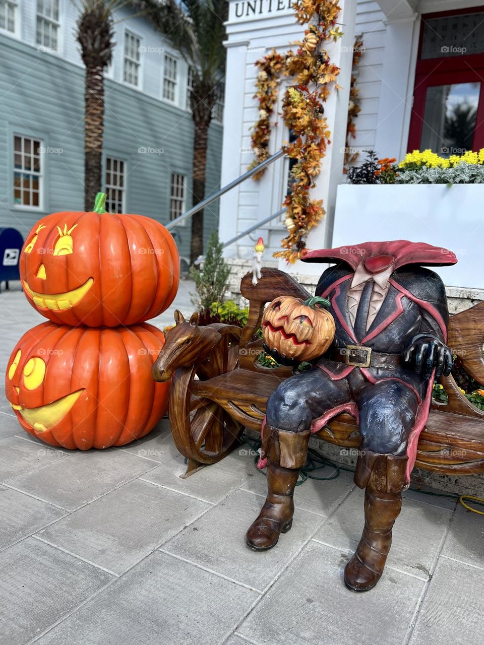 Halloween display of the Headless Horseman sitting on a bench outside a town post office