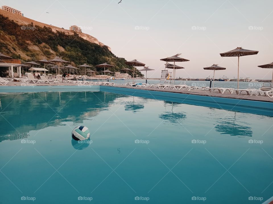 Lonely ball in the swimming pool on the seashore