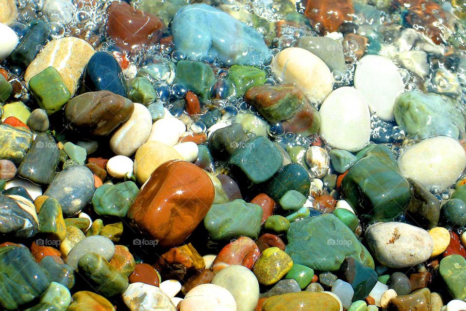 Colourful sea stones with bubles of water