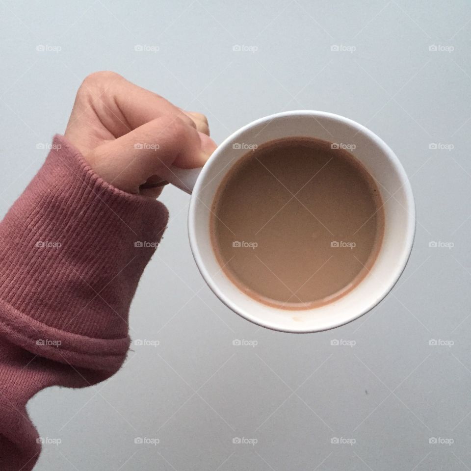 Holding a cup of coffee