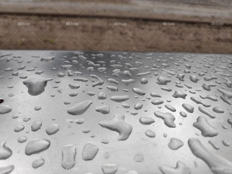 Water drops on metal bench