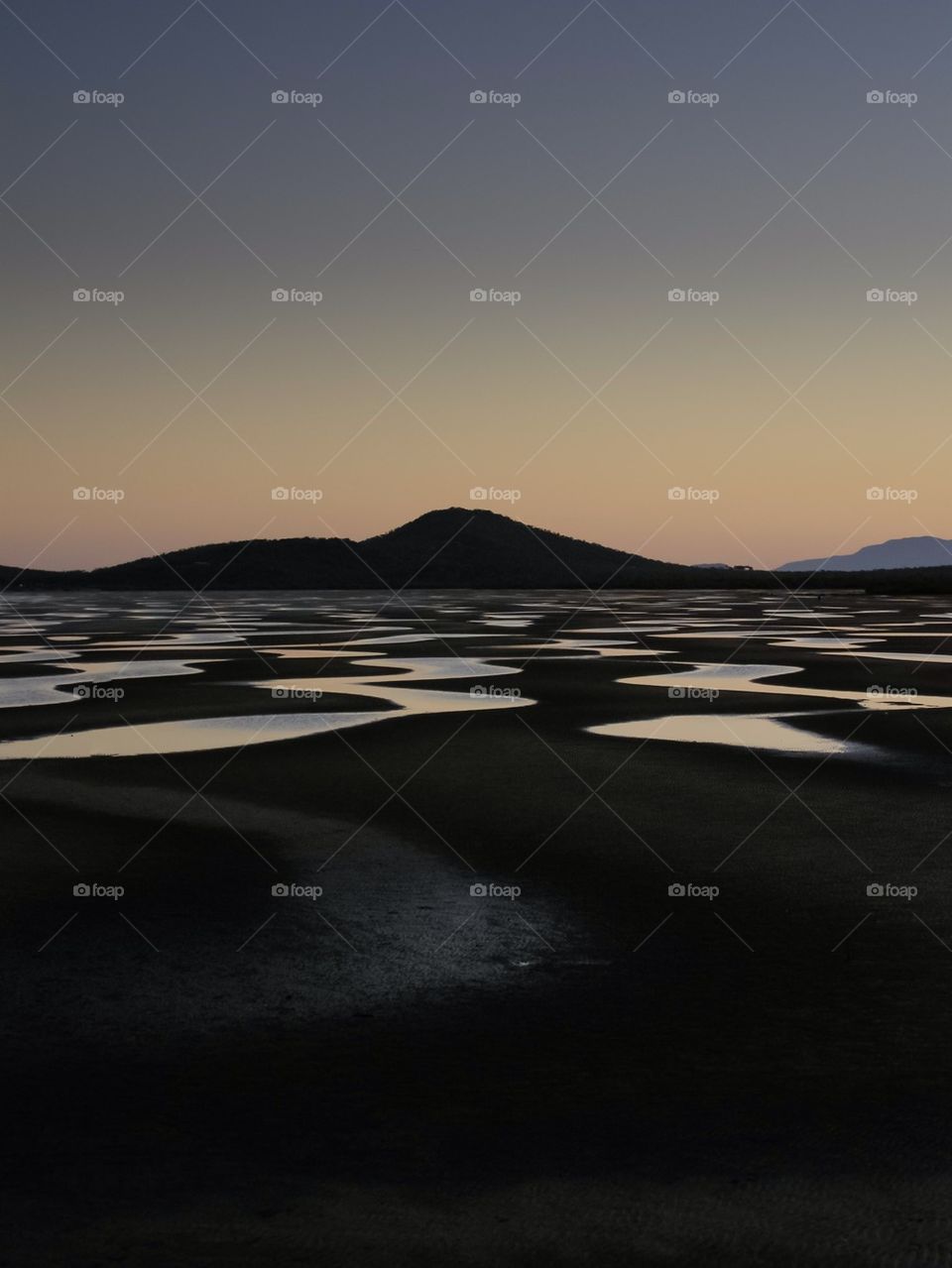 Silhouetted mountain during sunset