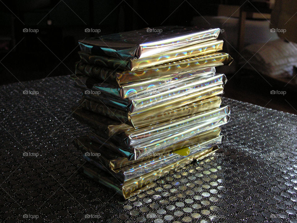 tower of flat wrapped presents in shiny wrapping paper