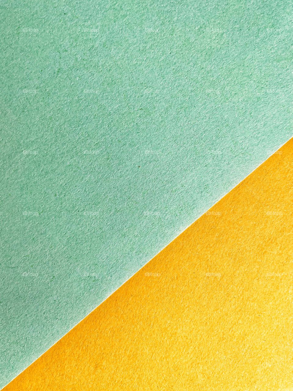 Full frame shot of rough green and yellow paper in triangle shape