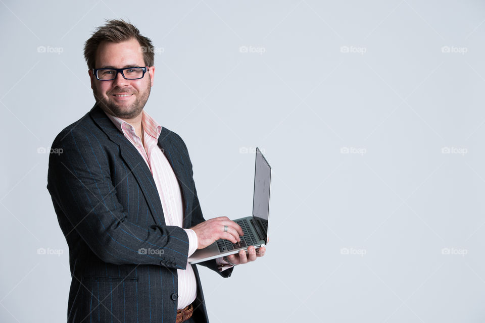 Close-up of a business man holding laptop