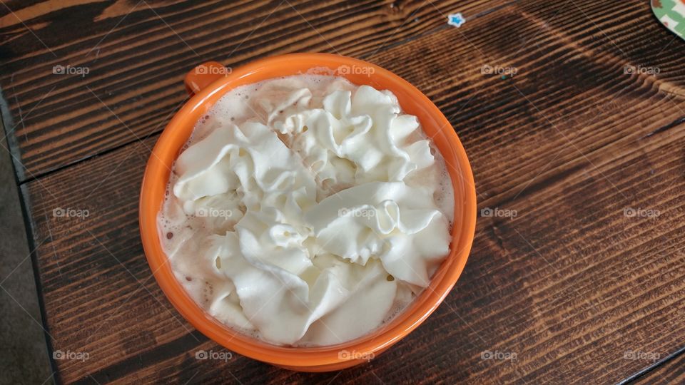 whip cream in cup over hot coco