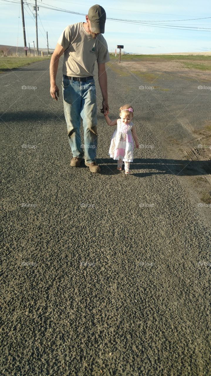 Father walking with daughter outdoors