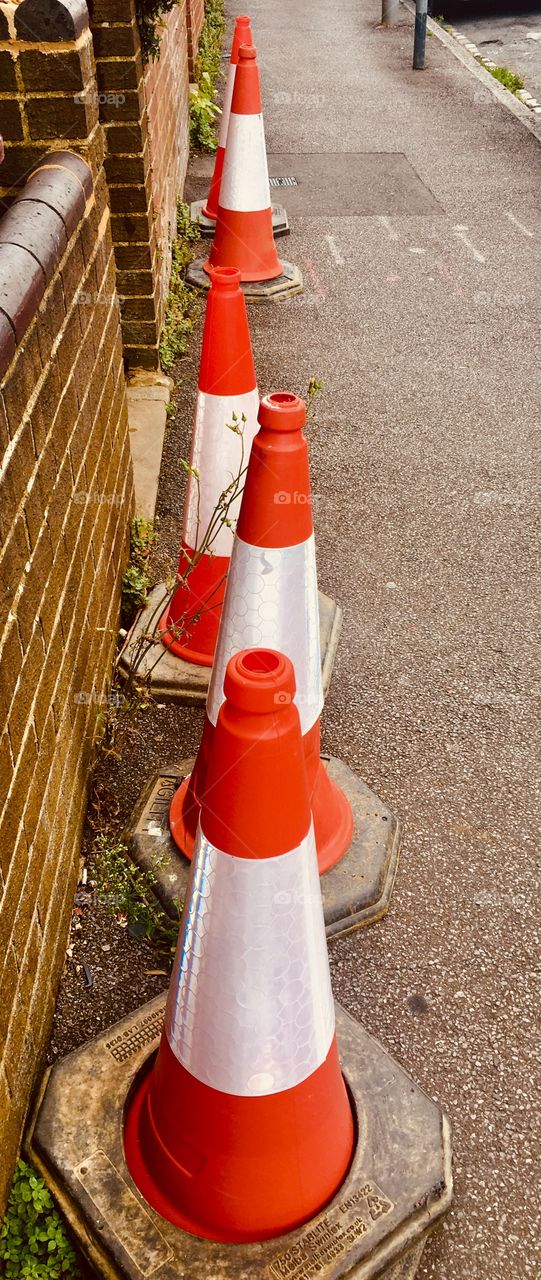 Orange barricade cones on street, United Kingdom 