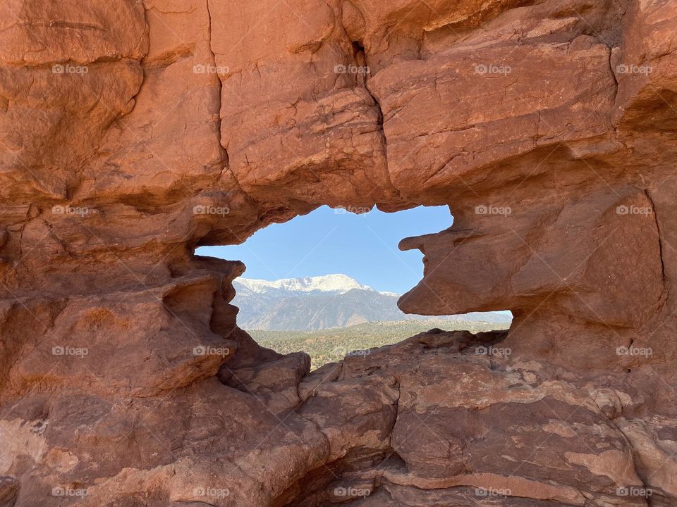 Pikes Peak seen through a rock window at Garden of the gods. 