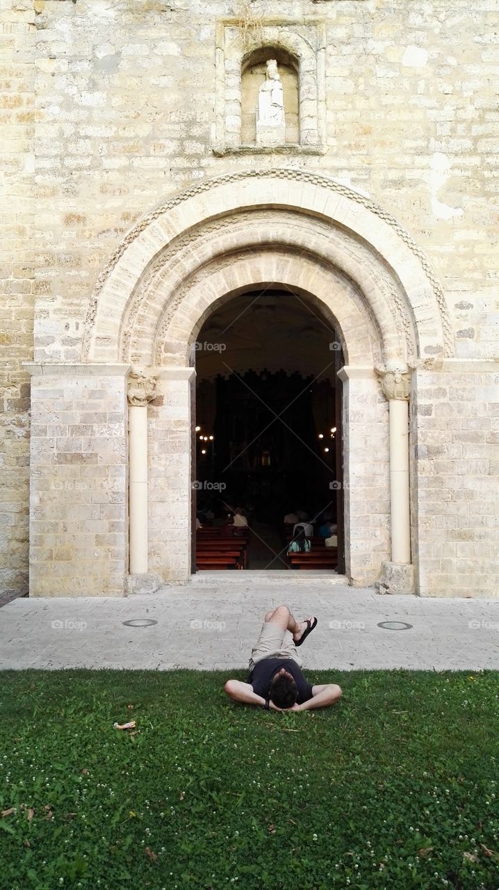 one man resting and relaxing looking at the church