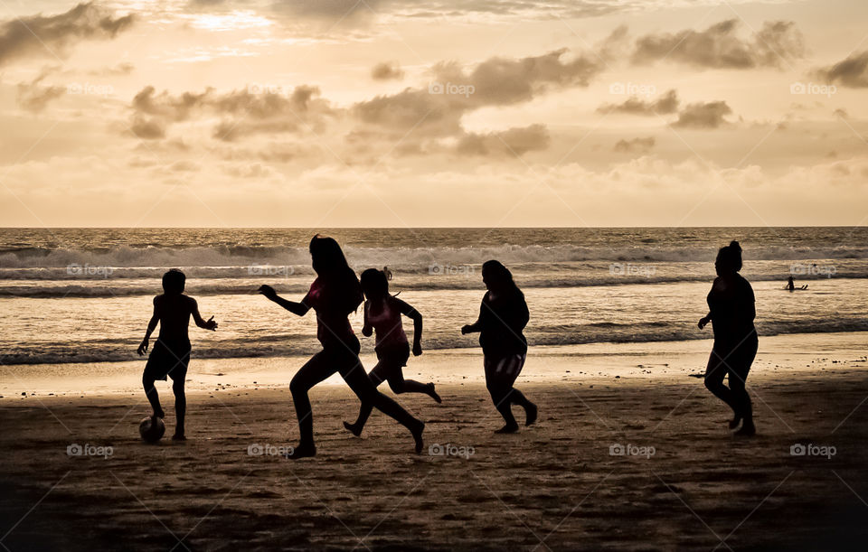 playing in the beach. soccer summer