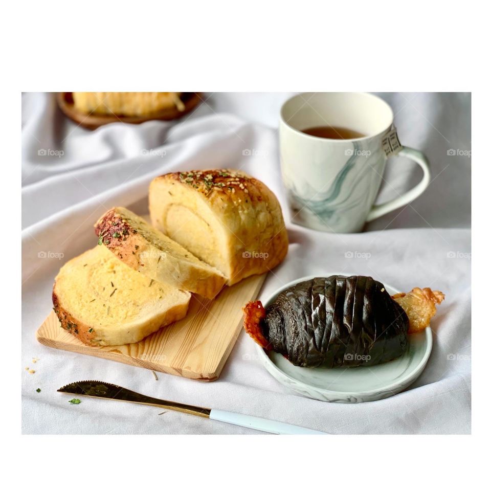 Garlic butter cheese bread with chocolate banana and chocolate cheese danish, paired with hot jackbean tea