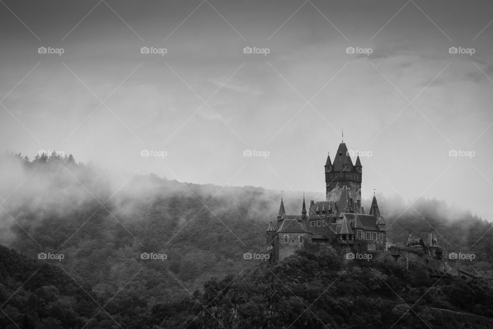Burg Cochem in morning fog. The forbidding Burg Cochem stands tall above the morning fog in Germany's Mosel Valley. 