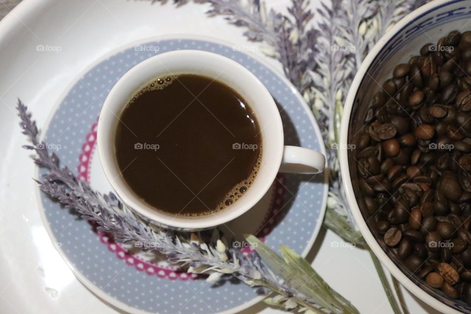 A cup of coffee and coffee beans