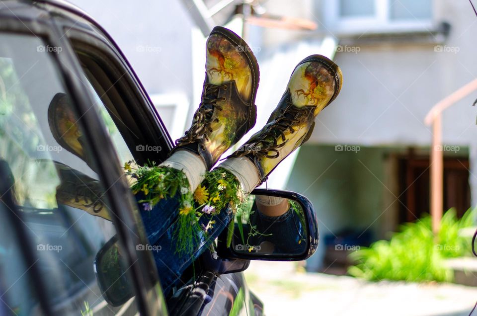 What's that doing here 😃? Woman Lying in Car With her Feet Out of Car Window. She Have Flowers Inside the Boots