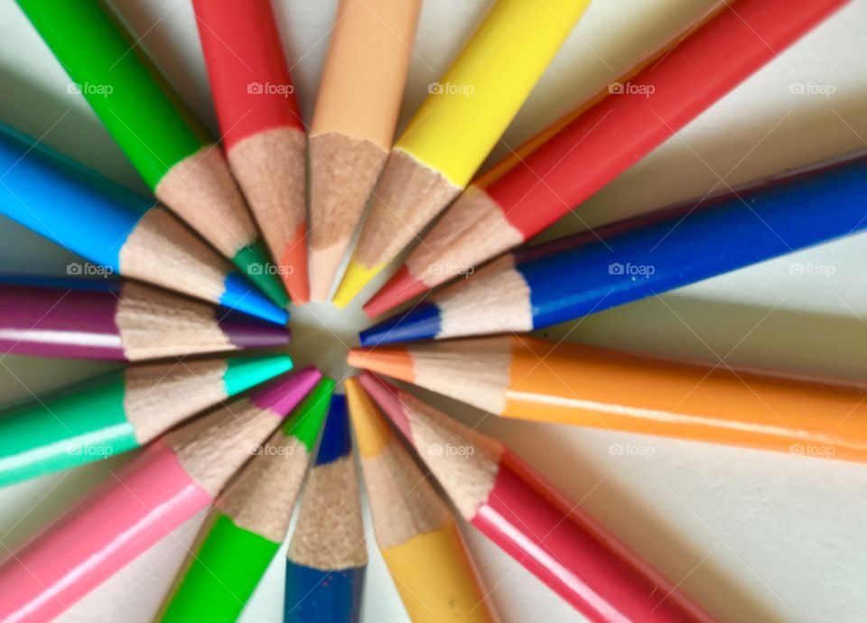 A circle of colored pencils with the sharpened tip of each pencil at the center. Very bright and colorful.