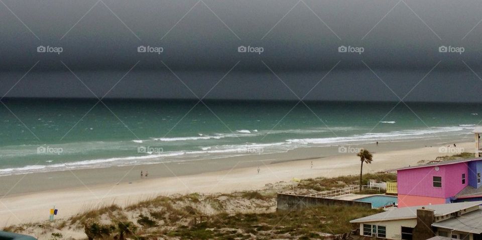Gray skies green ocean. Florida beach. 