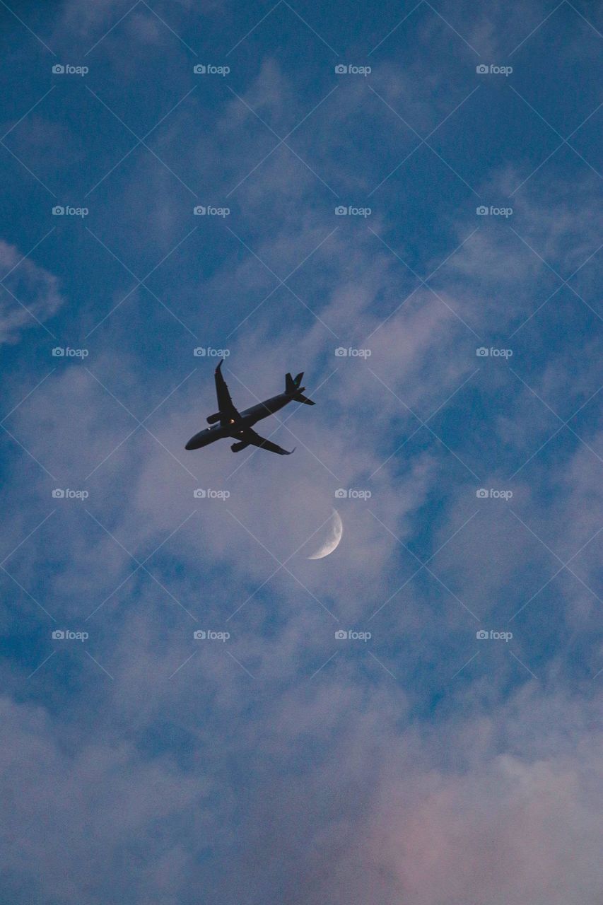 A plane flying in the sunset