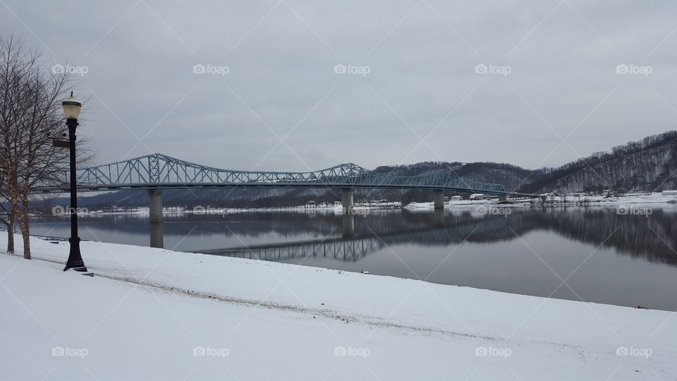 Bridge over the river at snowy day