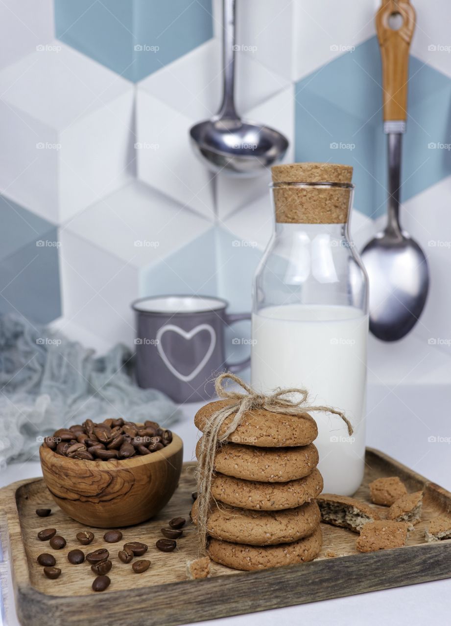 Oatmeal cookies and milk in a bright kitchen