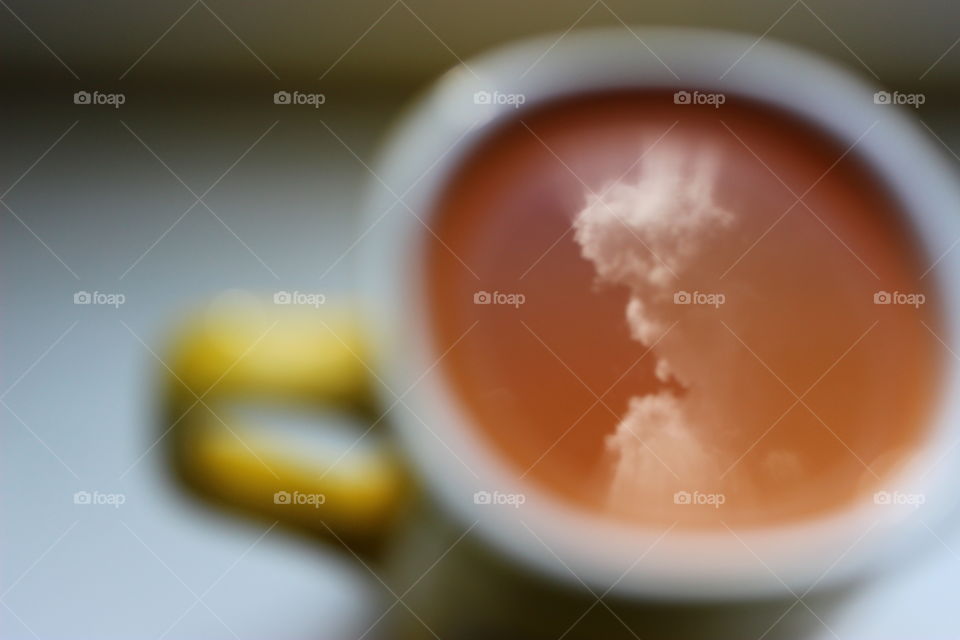 reflection of clouds in the cup of juice