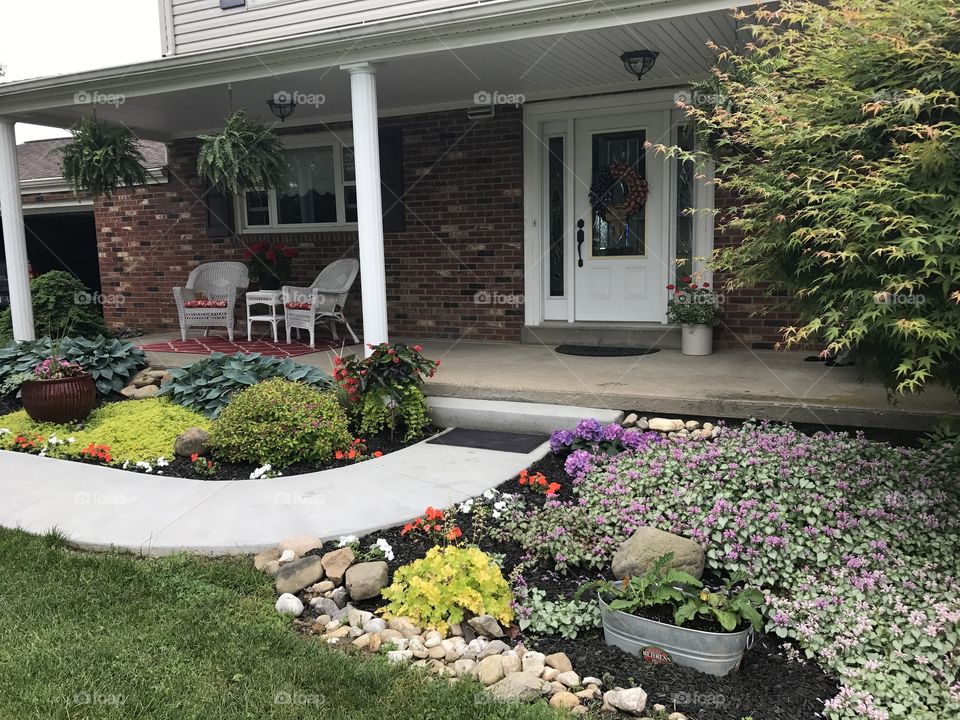 Plants in front yard house with front porch 