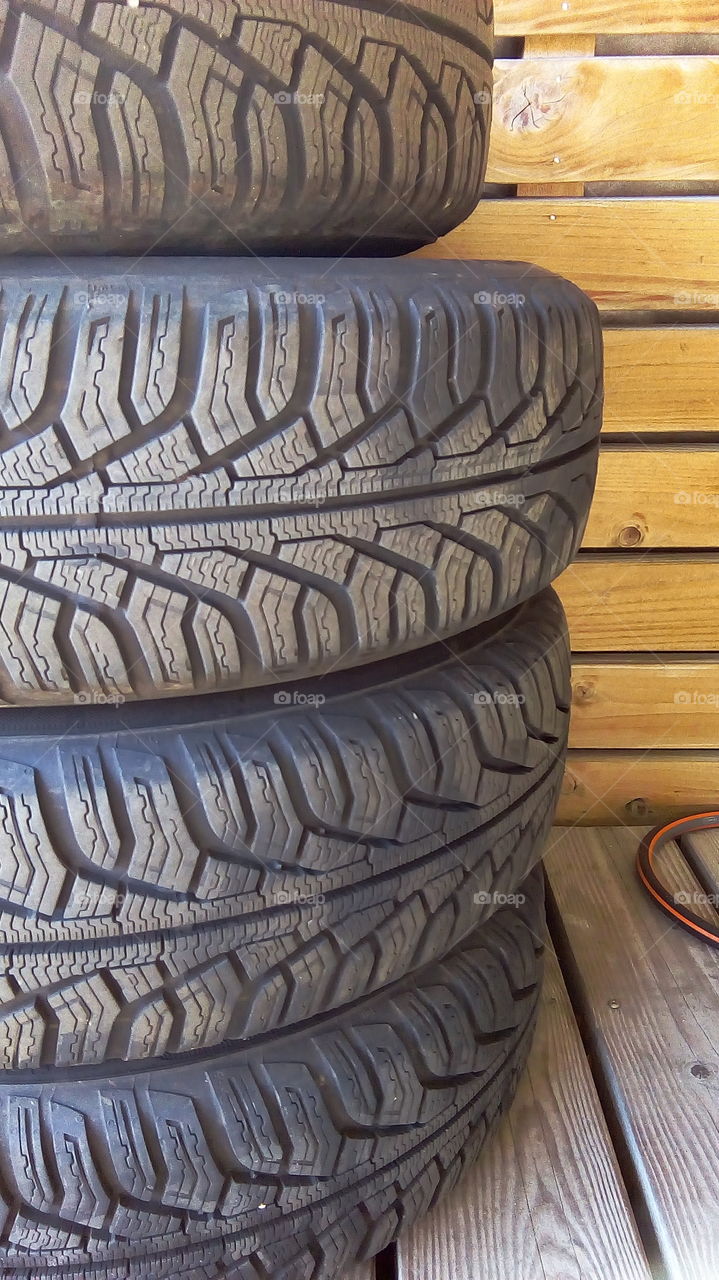 Tire through the use and wooden background