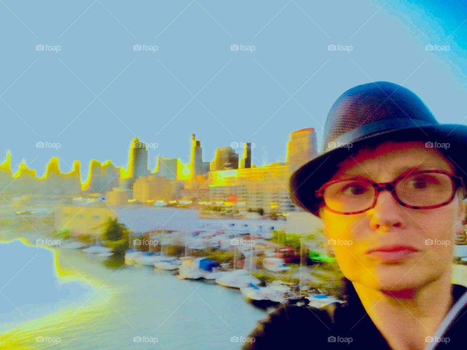 Photographer, artist & writer Petra Schiller stands on top of the Pulaski Bridge in LIC, Queens during the glorious time of a sunset so spectacular that it bathes an entire area in its golden glow. 2019. Hypnotic Productions