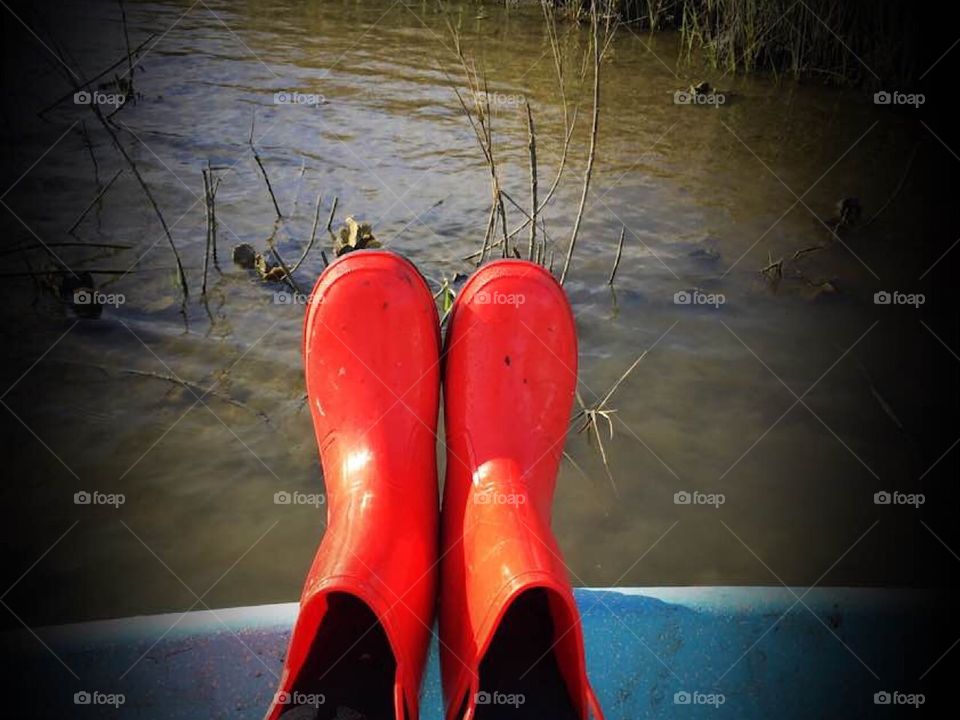 Boat, river, oysters, woman and her boating red boots 