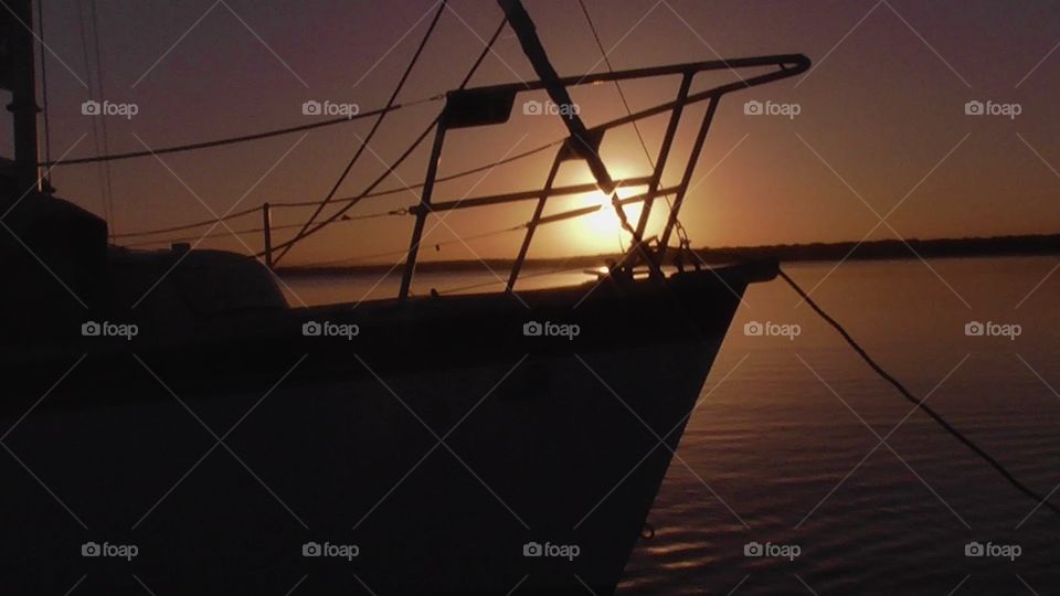 Yacht sitting in the calm waters off the South coast at sunset.