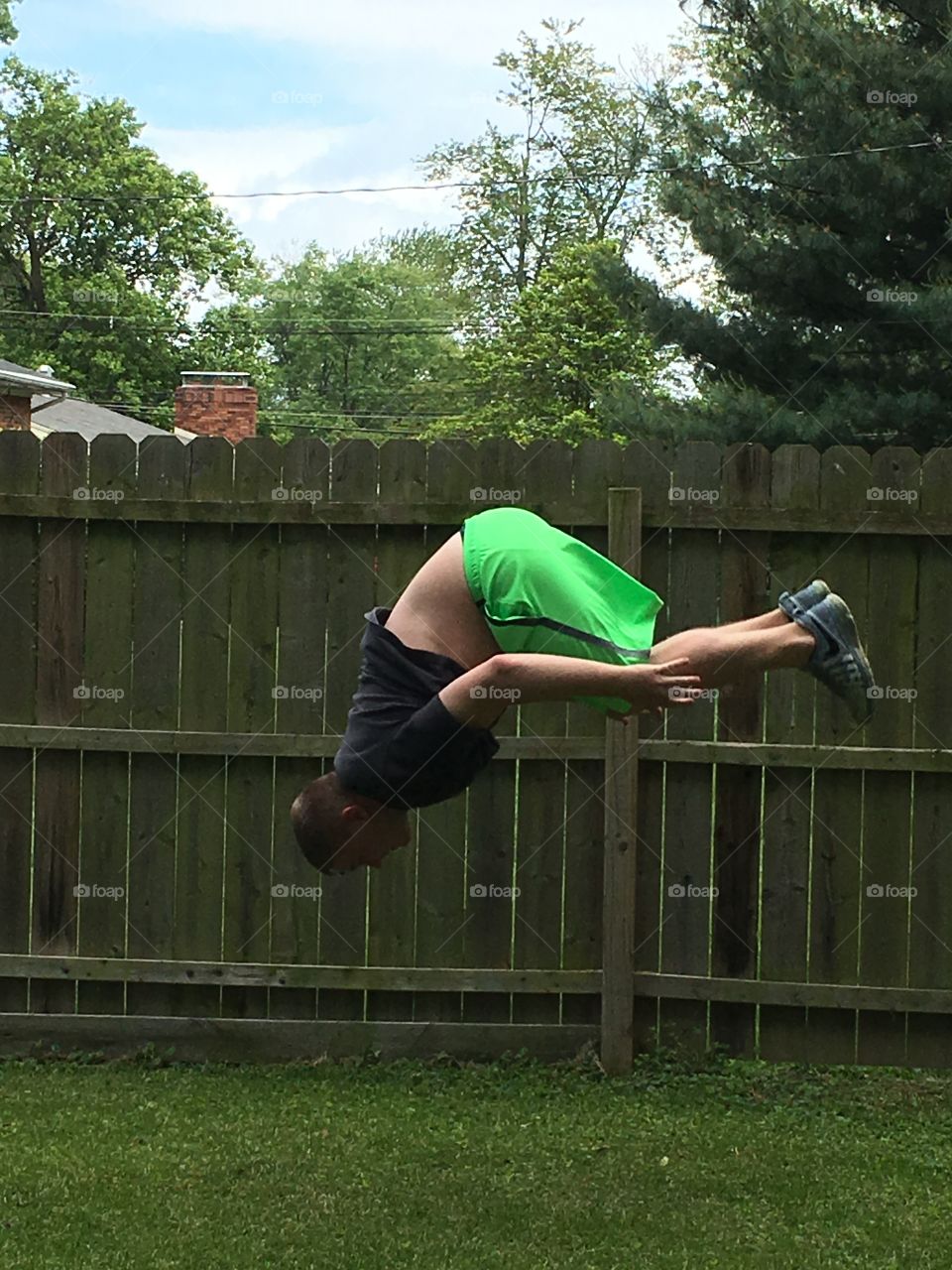 Man doing backflip at party 