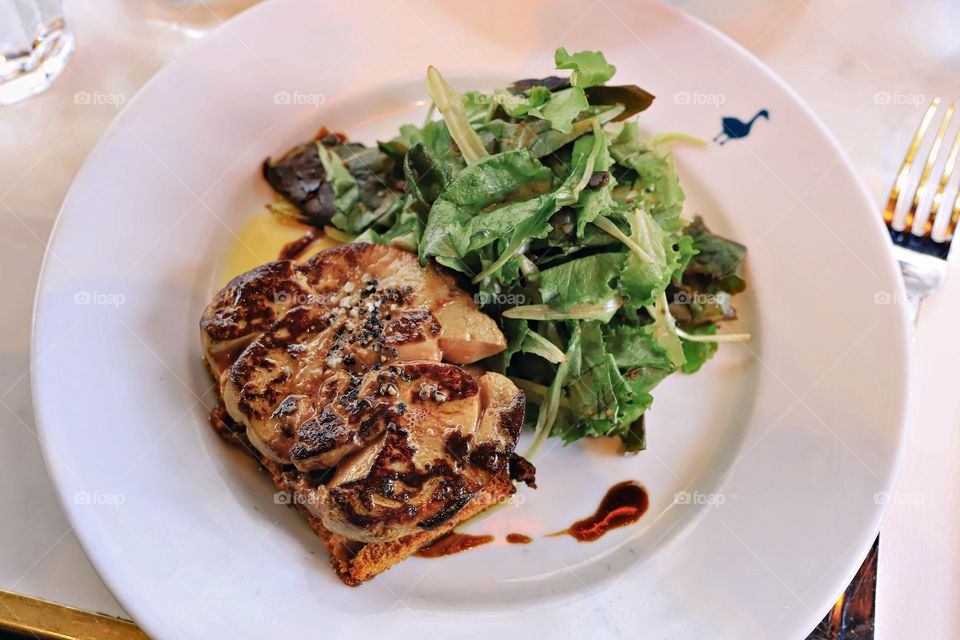 Mouthwatering tremendous foie gras with fresh salad 