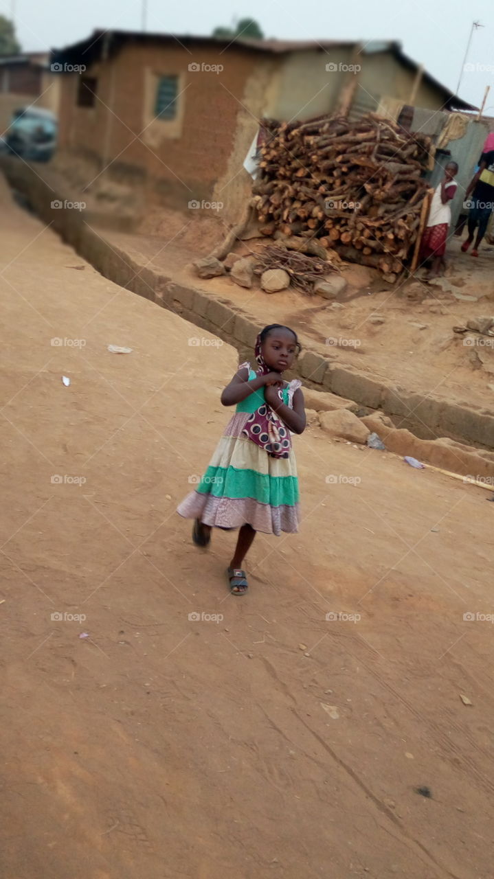 An African girl at sunset in a ghetto village in Abuja