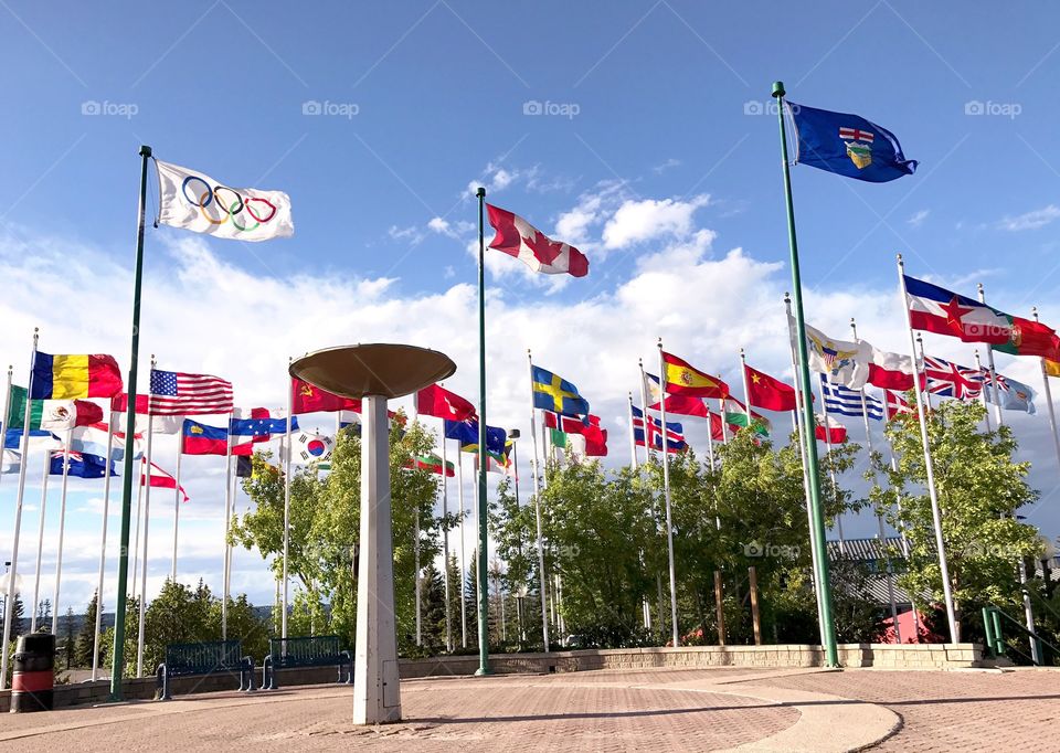 Flags from 1988 Winter Olympics in Calgary Canada. Flags still standing at Canada Olympic Park behind the torch. 