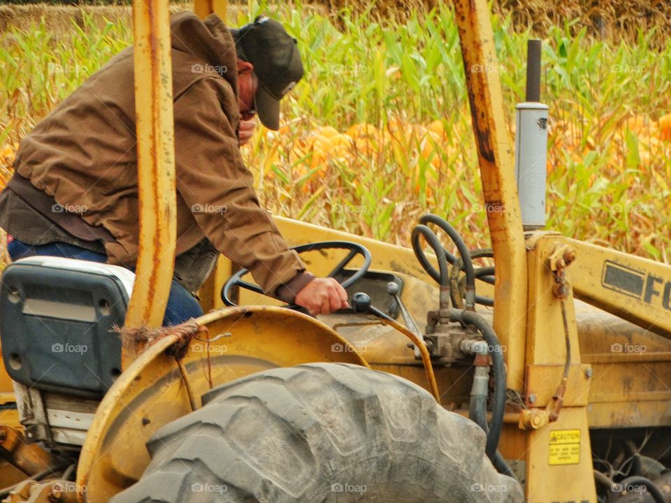 Old Farmer With His Tractor
