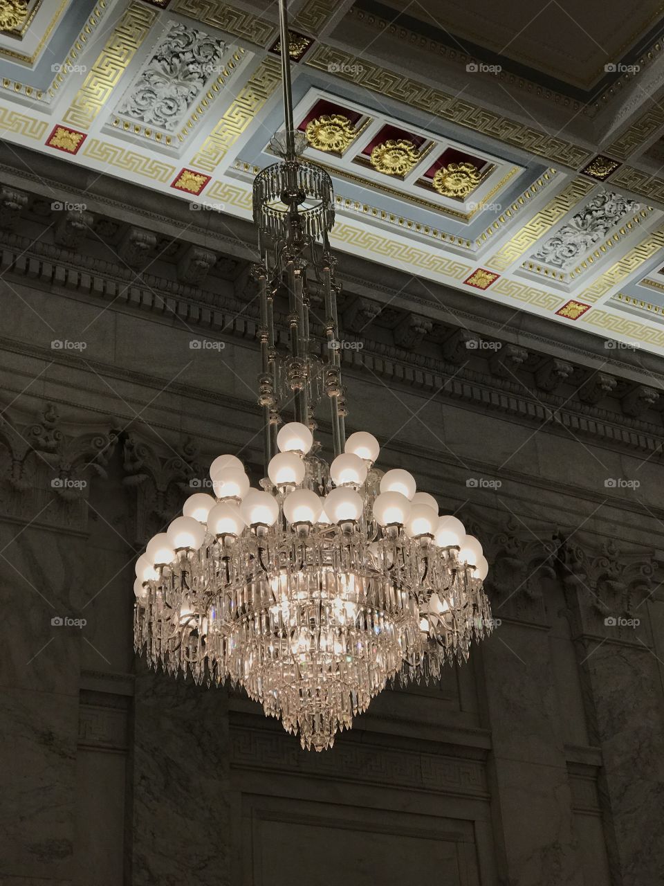 Fancy old chandelier hanging in the United States Senate building Kennedy caucus room 