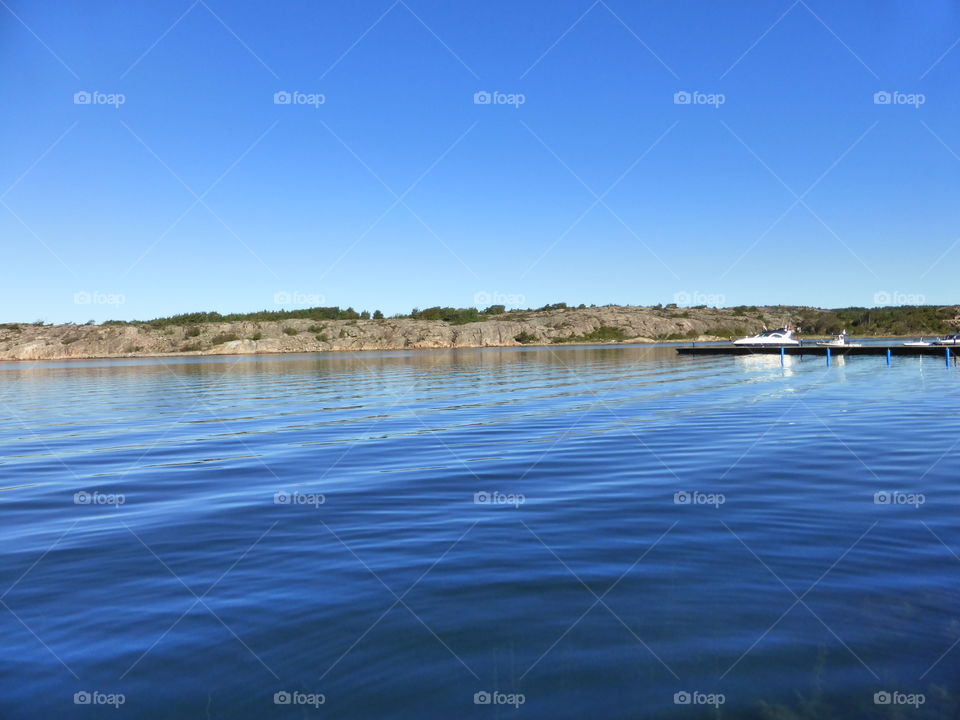 Clear sky over a blue sea