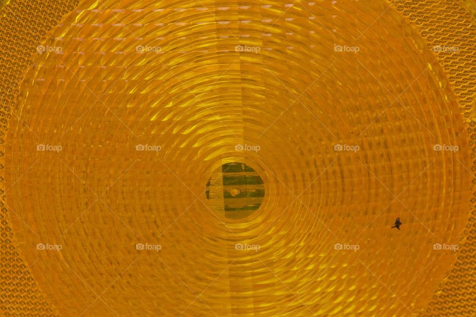 An abstract closeup of an orange construction warning light.