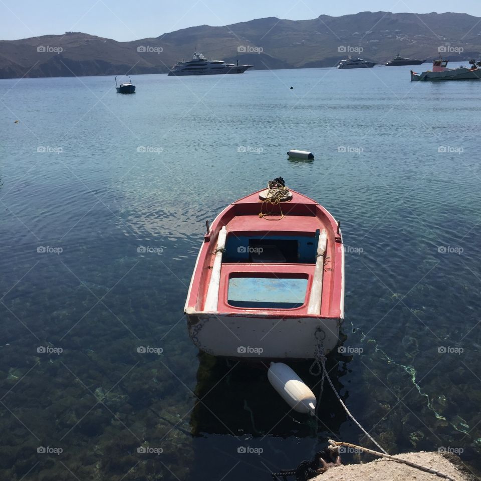 Small boat moored in Panormos bay, Mykonos, Greek island in the Aegean sea