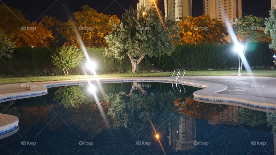 Swimmingpool#water#trees#reflect#buildings#lights#night