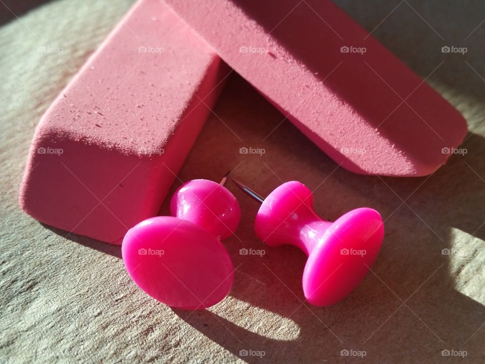 Pink erasers with pink push pins